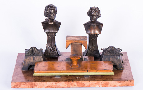 Garnitura de birou a lui Ioan Suciu, formată din 6 piese, din care două figurine , una ”Beethoven” și una ”Mozart”, așezate pe o placă din marmură. Lemn, marmură, metal, textil; placa de marmură: 26 x 39 cm; călimara: 8 x 7 cm; figurine: 18 x 6 cm; tambur sugativă: 25 x 10 x 7,5 cm. Achiziție, Ion Simion, Timișoara, p.v. nr. 954/26 iunie 1981.
