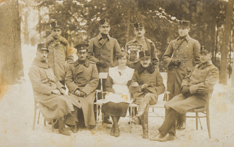 Grup de ofițeri din Primul Război Mondial. Romulus Rîmbaș este al treilea, de la stânga la dreapta, în rândul de sus. Fotografie sepia (tip carte poștală), 9 x 13 cm.  Donație, Nadia Rîmbaș, Sibiu, p.v. nr.18/12.03.1992.